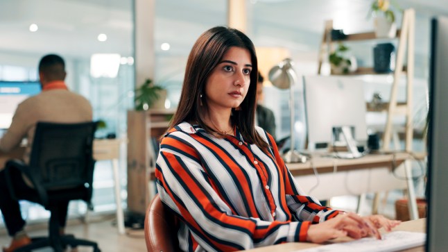 Serious, employee and woman with computer, office or journalist with story for magazine and creative. Newsroom, reporter and person with technology for article publication, productivity and coworking