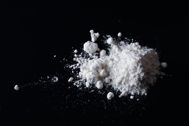 Pile of white powder on a black surface